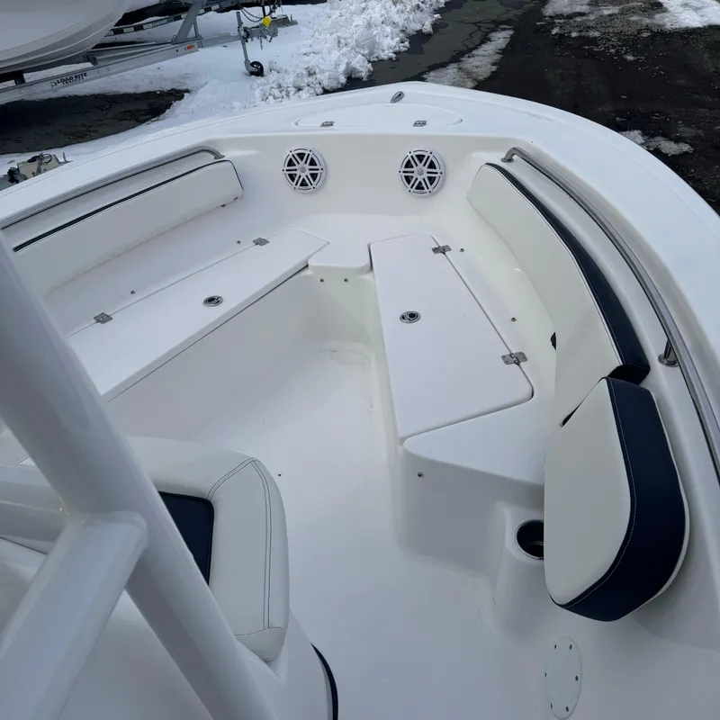 Slide: The Image of 2025 Tidewater 198 CC Adventure boat interior with white seating and storage compartments. - 26