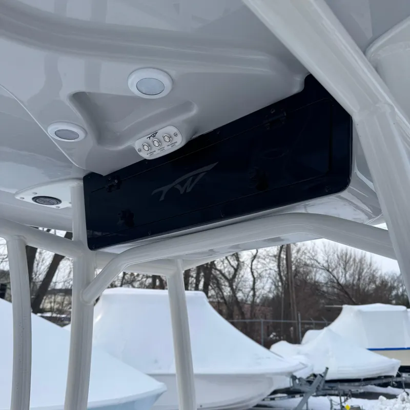 Slide: The Image of 2025 Tidewater 198 CC Adventure boat T-top with integrated lighting and storage. - 28
