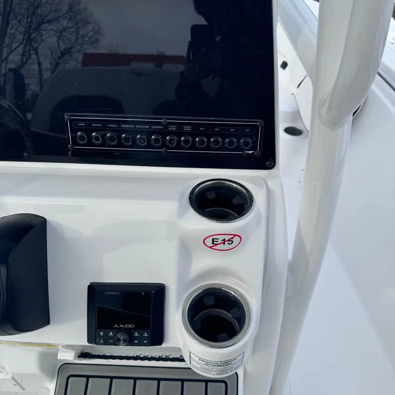 Slide: The Image of Center console of 2025 Tidewater 198 CC Adventure boat with controls and cup holders. - 29