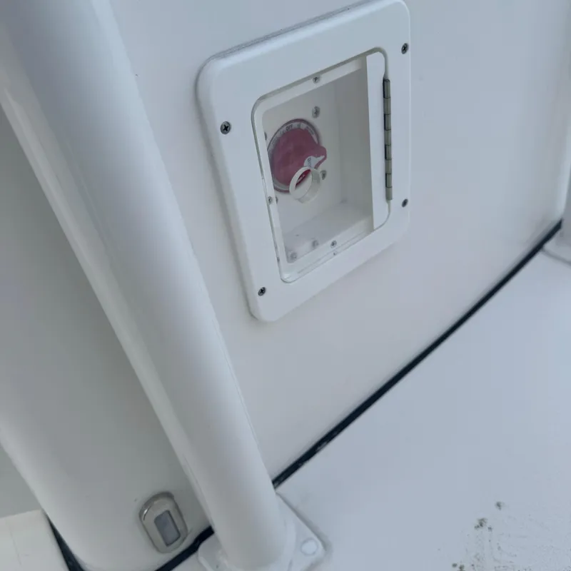 Slide: The Image of 2025 Tidewater 198 CC Adventure boat detail, featuring a white panel with a red dial. - 35