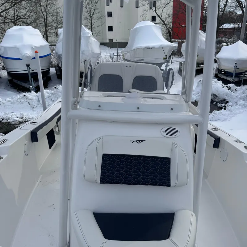 Slide: The Image of 2025 Tidewater 198 CC Adventure boat in snowy storage, surrounded by covered boats. - 41
