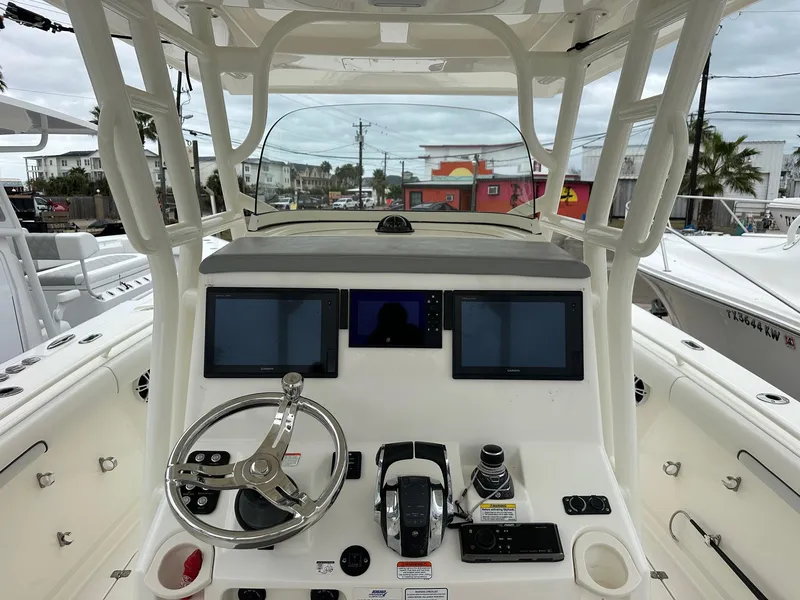 Slide: The Image of 2019 Mako 334 CC boat dashboard with steering wheel and electronic displays. - 3