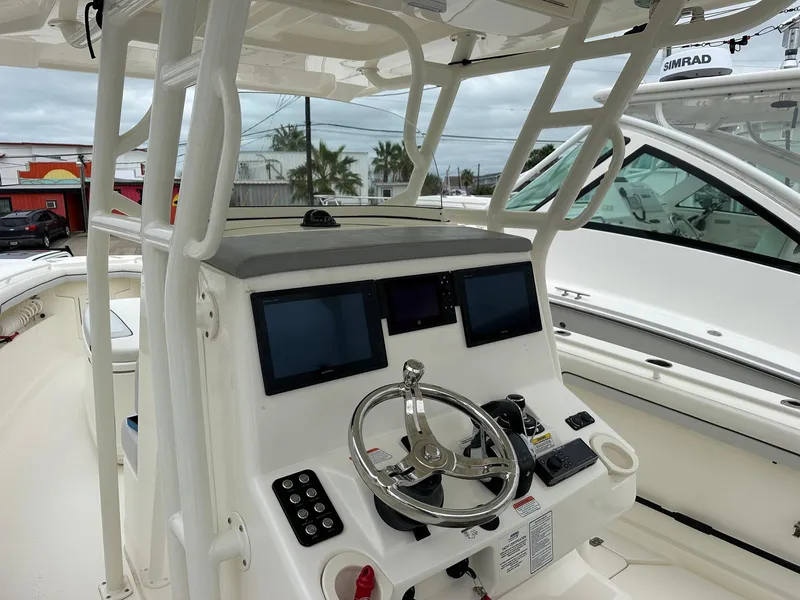 Slide: The Image of 2019 Mako 334 CC boat helm with modern navigation displays and controls. - 4