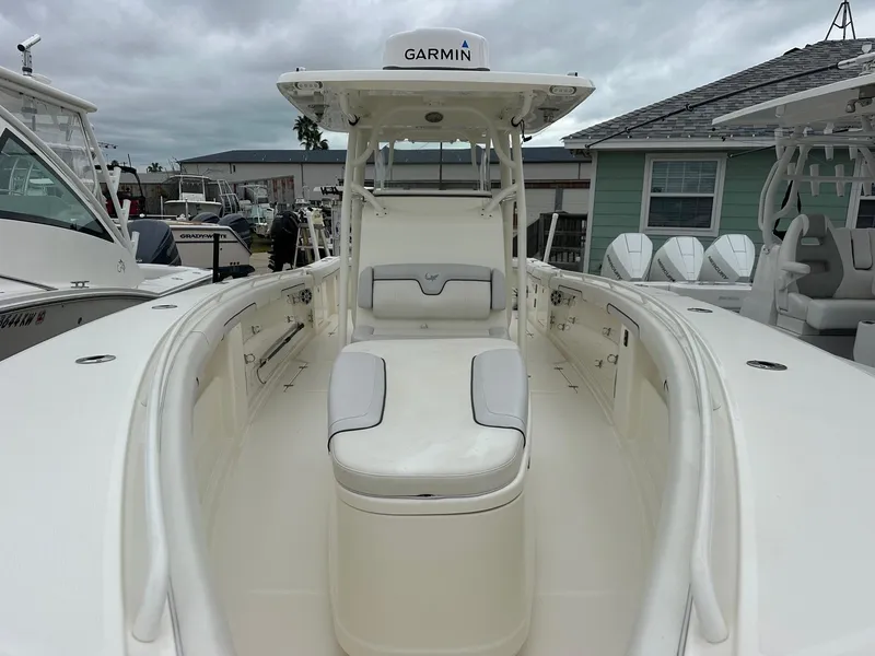 Slide: The Image of 2019 Mako 334 CC boat with Garmin equipment, docked in a marina. - 8