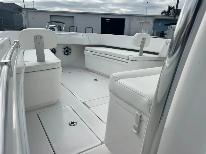 Slide: The Image of 2023 Contender 30T boat interior with white seating and storage compartments. - 12