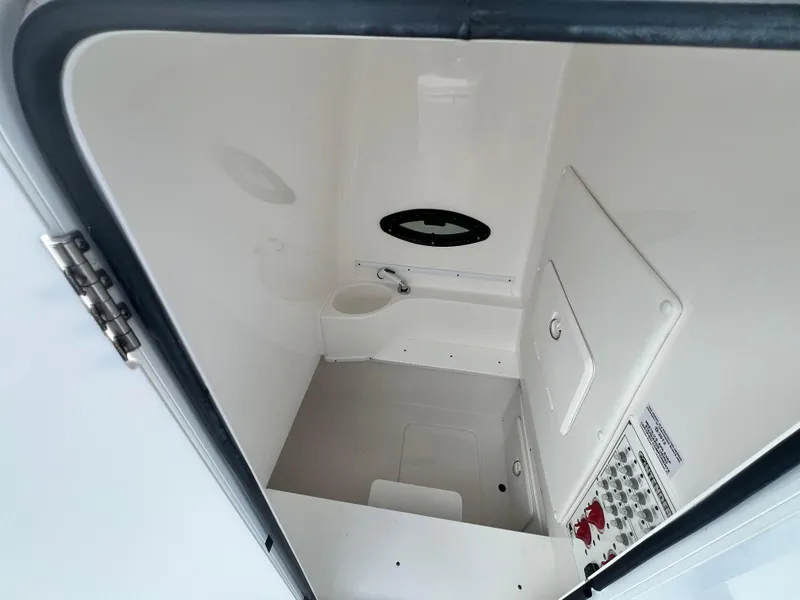 Slide: The Image of 2023 Contender 30T boat interior compartment with control panel and storage. - 14