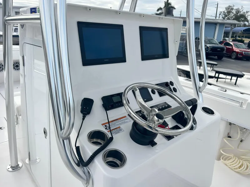 Slide: The Image of 2023 Contender 30T boat console with dual screens and steering wheel. - 15