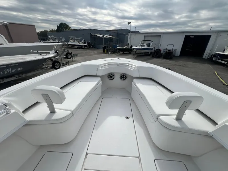 Slide: The Image of 2023 Contender 30T boat interior with white seating, docked at a marina. - 20