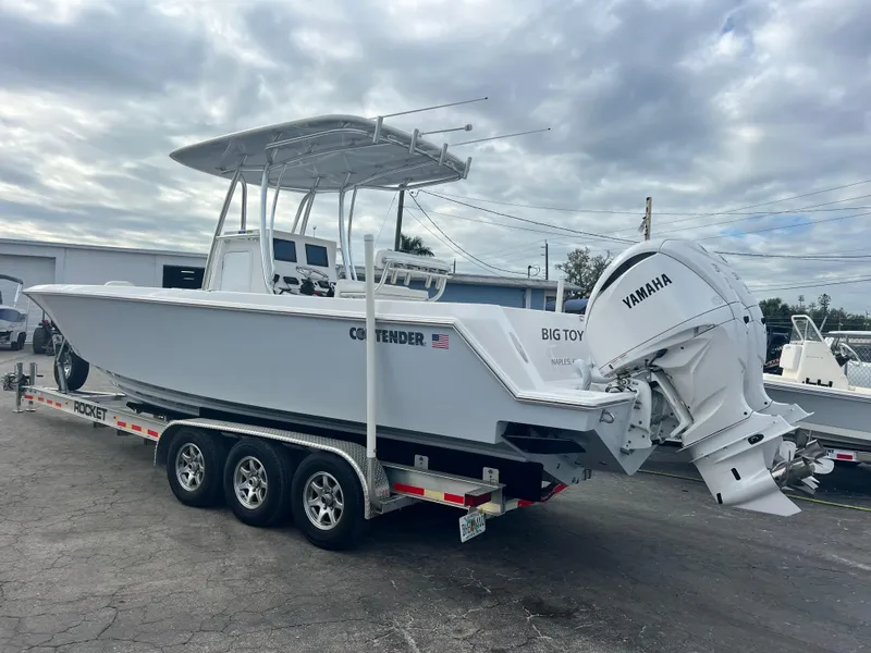 Slide: The Image of 2023 Contender 30T boat on trailer with Yamaha engine, parked outdoors. - 4
