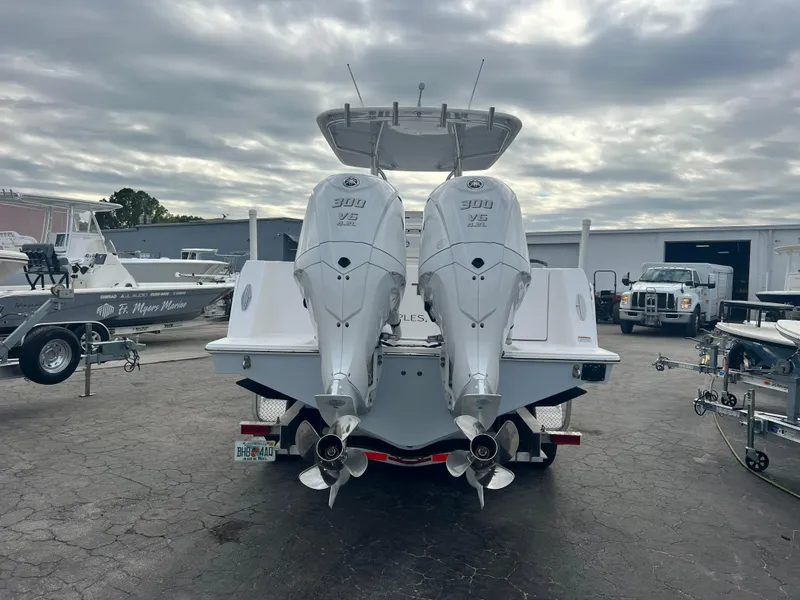 Slide: The Image of 2023 Contender 30T boat with twin 300 V6 engines, parked outdoors. - 5