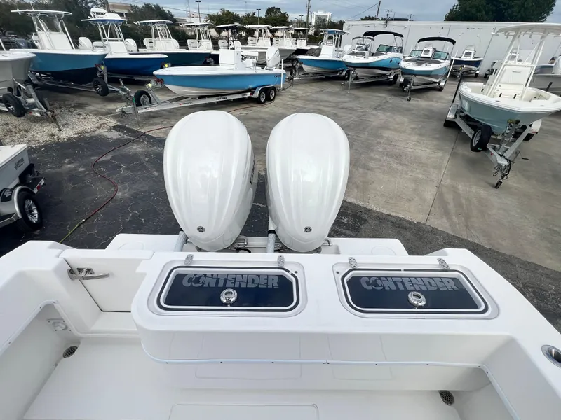 Slide: The Image of 2023 Contender 30T boat with dual engines, displayed in a marina setting. - 6