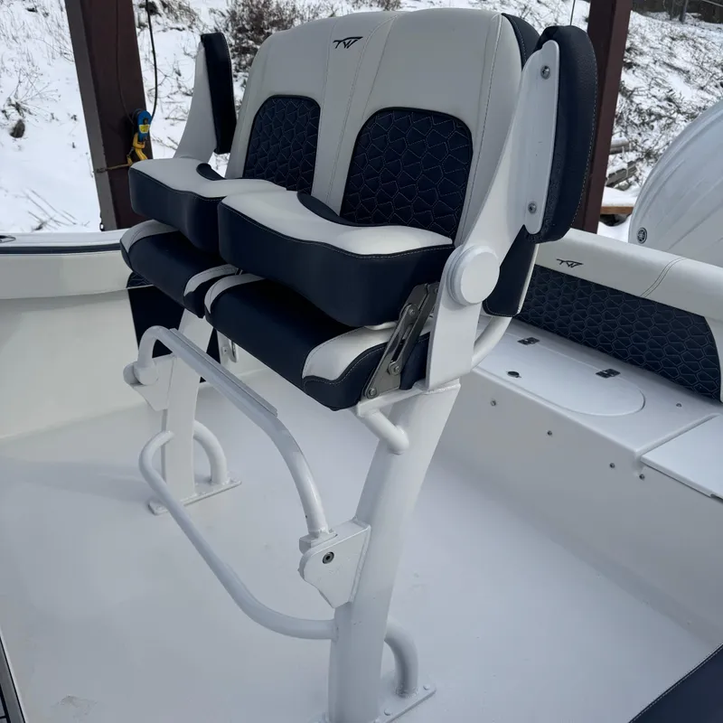 Slide: The Image of Tidewater 220 LXF 2025 boat seating with white and black cushioned seats. - 13