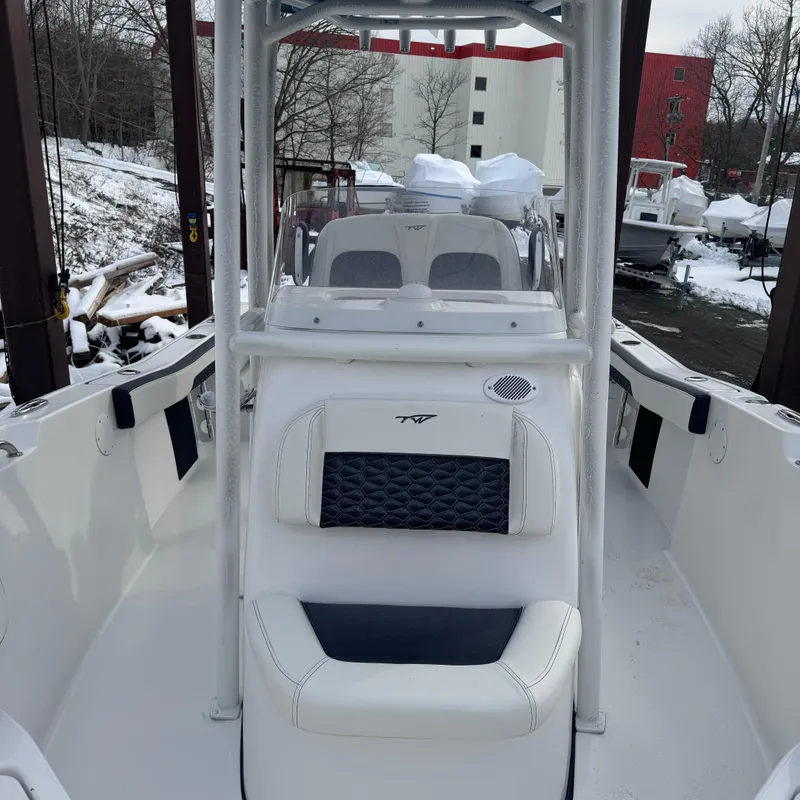 Slide: The Image of 2025 Tidewater 220 LXF boat interior with seating and console, in a snowy outdoor setting. - 17