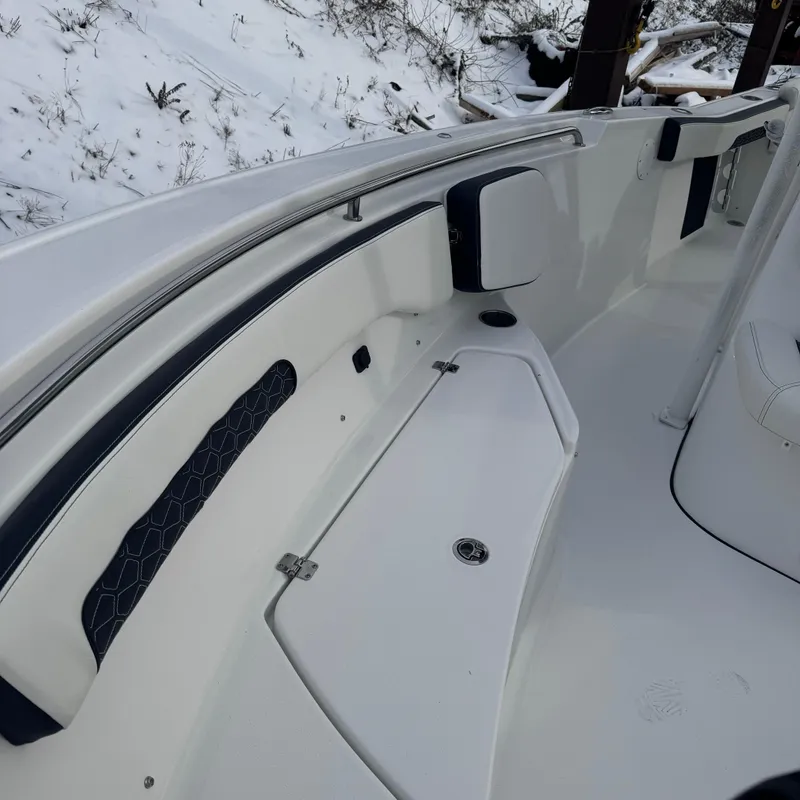 Slide: The Image of 2025 Tidewater 220 LXF boat interior with sleek white seating and storage. - 18