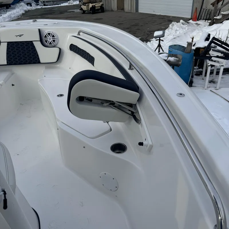 Slide: The Image of 2025 Tidewater 220 LXF boat interior with seating and speaker, docked in snowy area. - 19