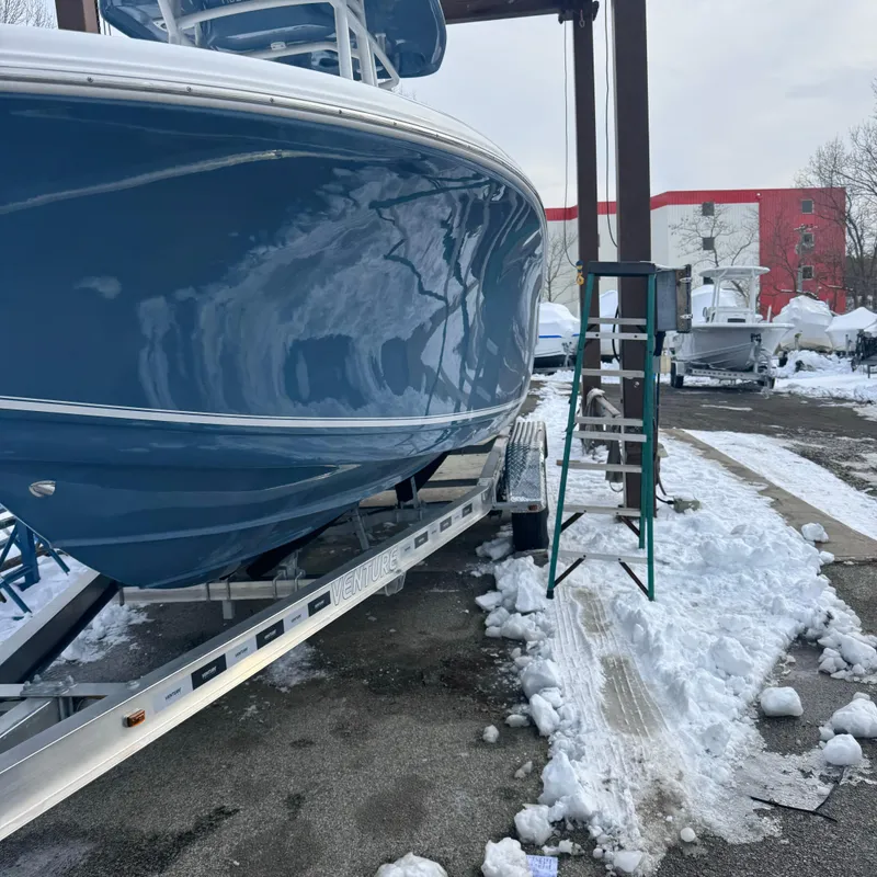 Slide: The Image of 2025 Tidewater 220 LXF boat on trailer in snowy outdoor setting. - 2