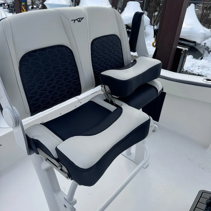 Slide: The Image of 2025 Tidewater 220 LXF boat seats with navy and white upholstery, snowy background. - 20