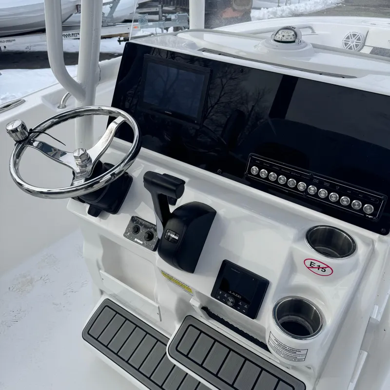Slide: The Image of 2025 Tidewater 220 LXF boat console with steering wheel and controls. - 21
