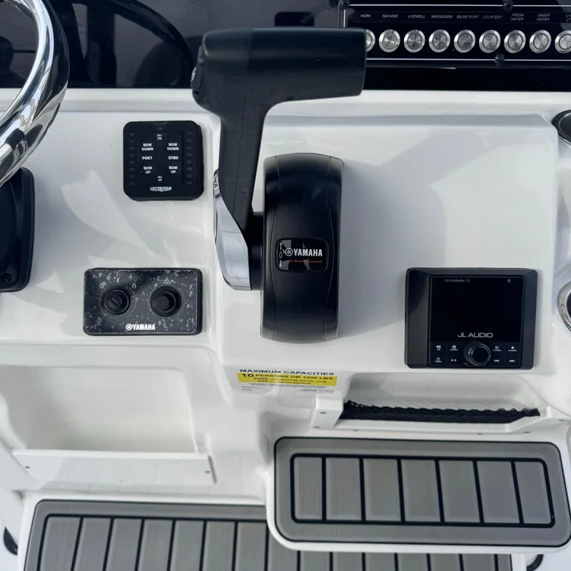 Slide: The Image of 2025 Tidewater 220 LXF boat console with Yamaha controls and JL Audio system. - 23