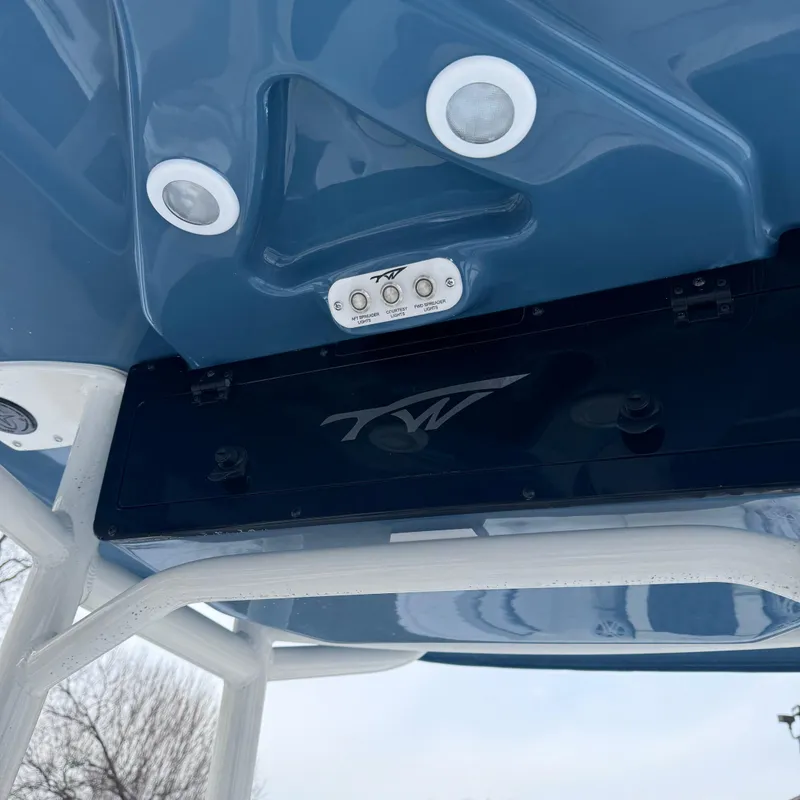 Slide: The Image of 2025 Tidewater 220 LXF boat underside with lights and logo detail. - 25