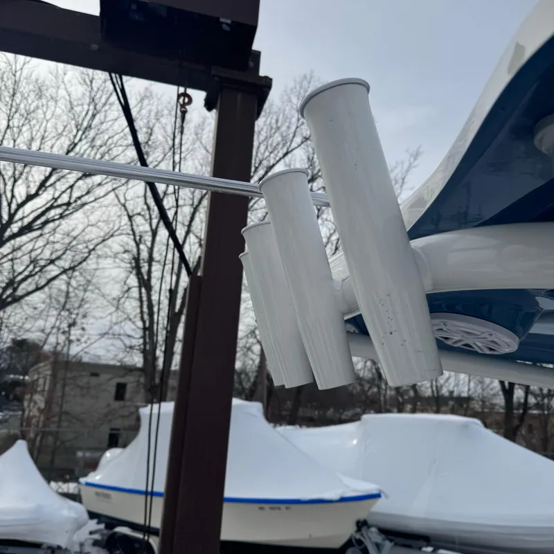 Slide: The Image of Tidewater 220 LXF 2025 boat with rod holders, winter storage in background. - 29