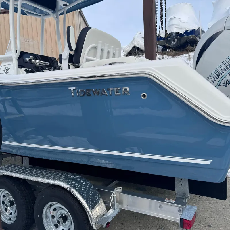 Slide: The Image of 2025 Tidewater 220 LXF boat on trailer, blue hull, outdoor setting. - 3