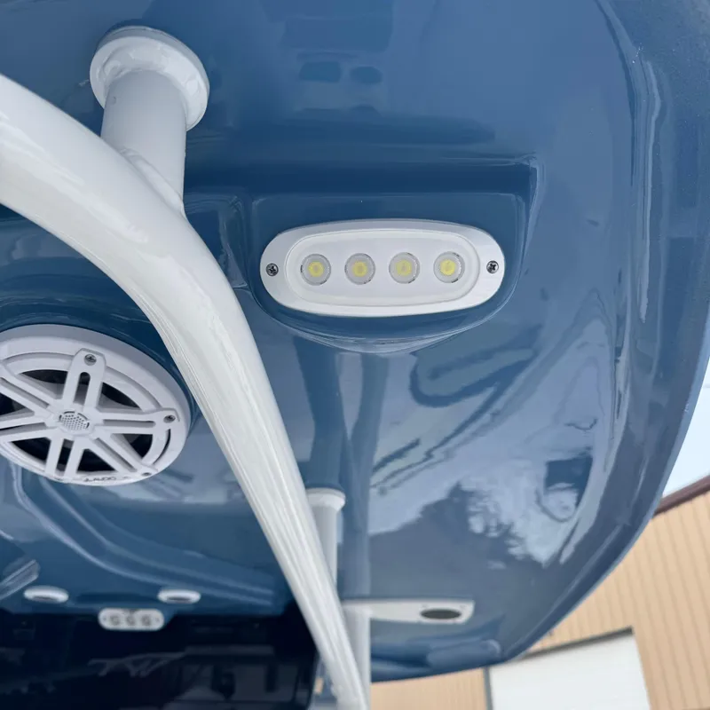Slide: The Image of LED lights and speaker on 2025 Tidewater 220 LXF boat's blue hull. - 31