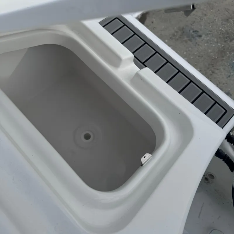 Slide: The Image of 2025 Tidewater 220 LXF boat compartment, open lid, white interior. - 34