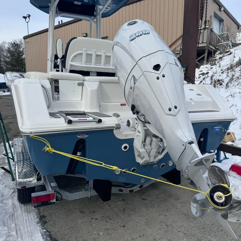 Slide: The Image of 2025 Tidewater 220 LXF boat with outboard motor on a trailer in snowy setting. - 5