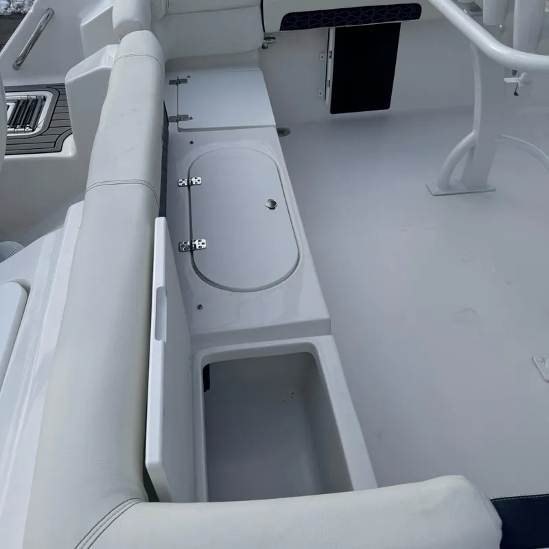 Slide: The Image of 2025 Tidewater 220 LXF boat interior with seating and storage compartments. - 6