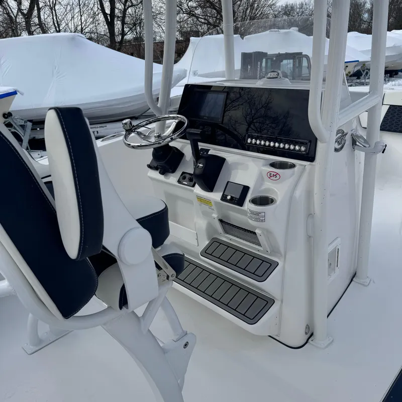 Slide: The Image of 2025 Tidewater 220 LXF boat cockpit with steering wheel and controls. - 7