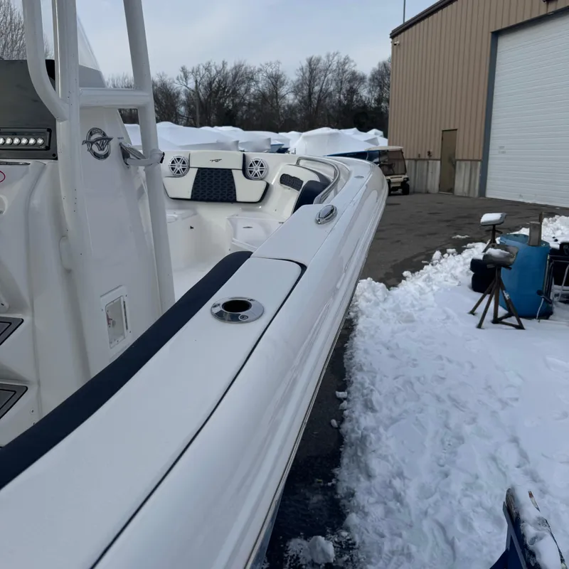Slide: The Image of 2025 Tidewater 220 LXF boat in snowy outdoor setting near a warehouse. - 8