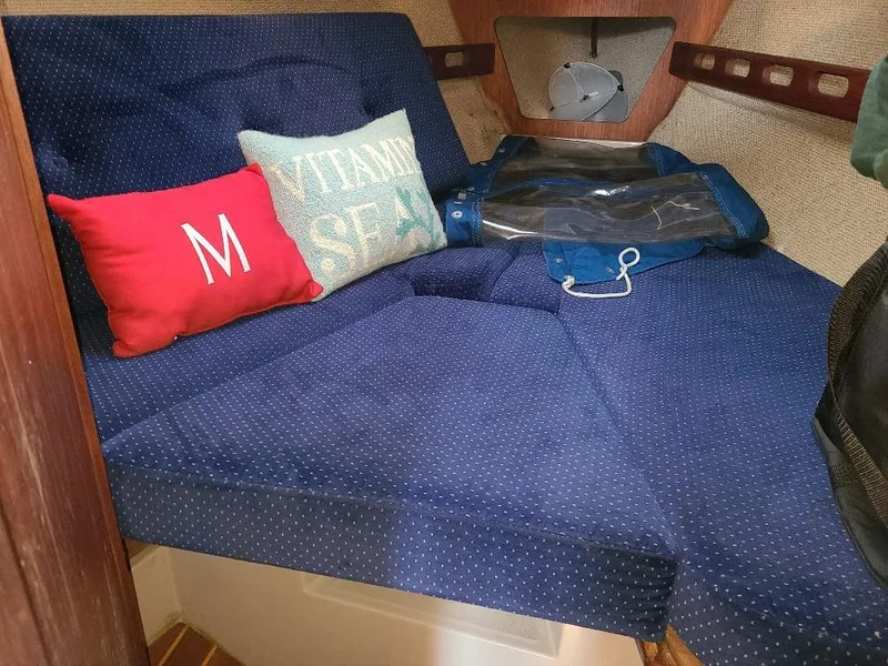 Slide: The Image of Cozy cabin interior of 1985 O'Day 35 sailboat with blue cushions and decorative pillows. - 14
