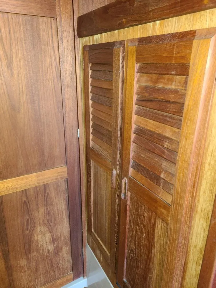 Slide: The Image of Wooden interior of 1985 O'Day 35 sailboat with louvered doors. - 15