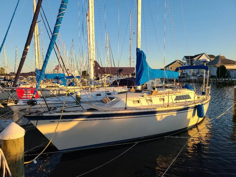 Slide: The Image of 1985 O'Day 35 sailboat docked at marina, blue covers, sunny day. - 2