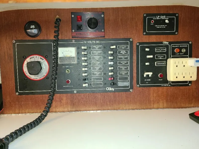 Slide: The Image of Control panel of a 1985 O'Day 35 sailboat with various switches and gauges. - 20