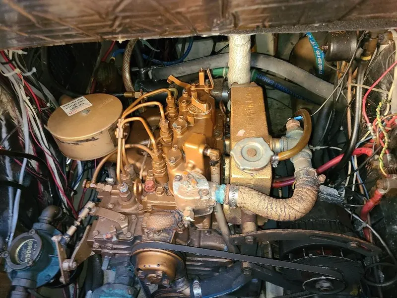 Slide: The Image of Engine compartment of a 1985 O'Day 35 sailboat, showcasing intricate mechanical components. - 21