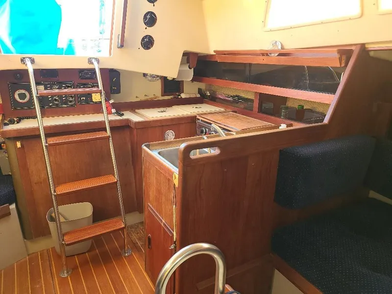 Slide: The Image of Interior of 1985 O'Day 35 sailboat with wooden cabinetry and navigation equipment. - 24