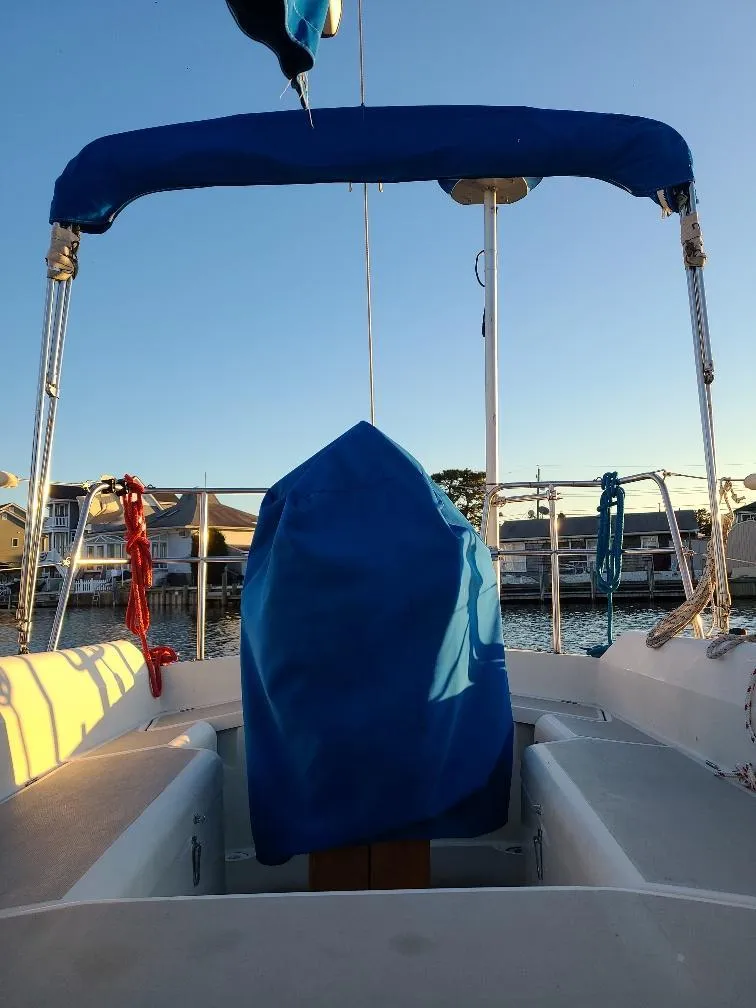 Slide: The Image of 1985 O'Day 35 sailboat cockpit with blue cover, docked at marina. - 27