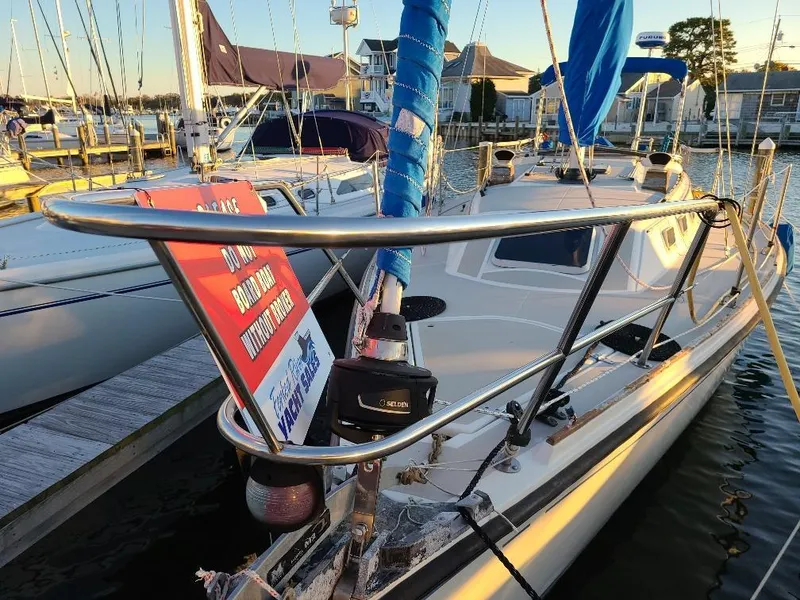 Slide: The Image of 1985 O'Day 35 sailboat docked at marina with warning sign. - 3