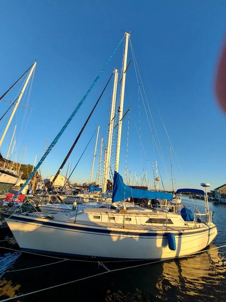 Slide: The Image of 1985 O'Day 35 sailboat docked in a marina under clear blue skies. - 31