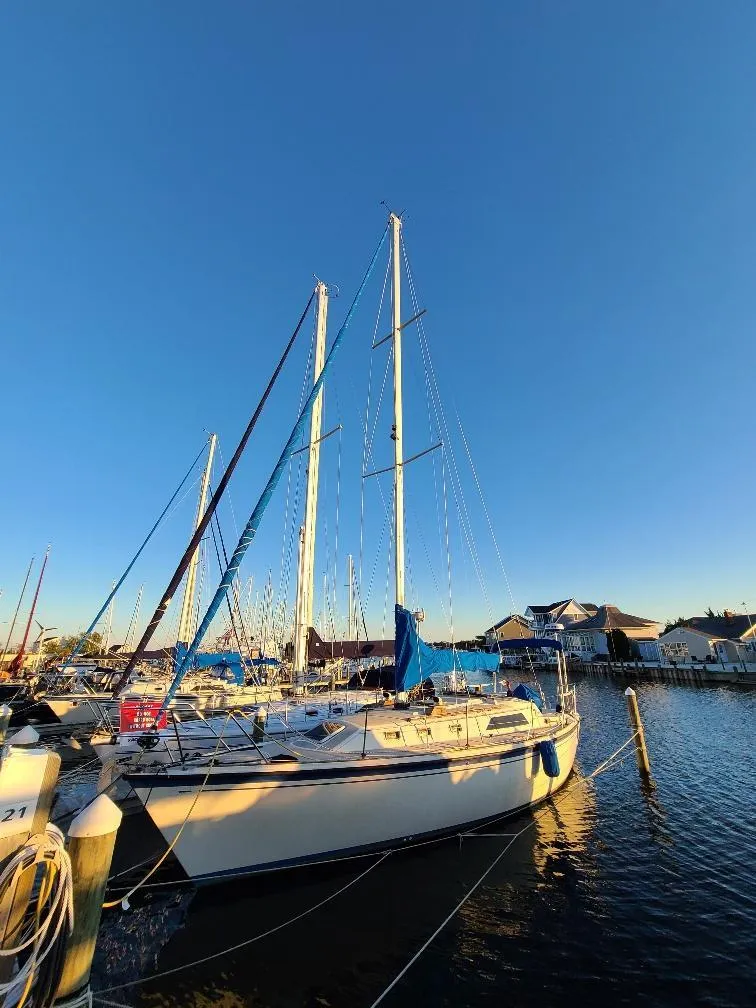 Slide: The Image of 1985 O'Day 35 sailboat docked at marina under clear blue sky. - 4