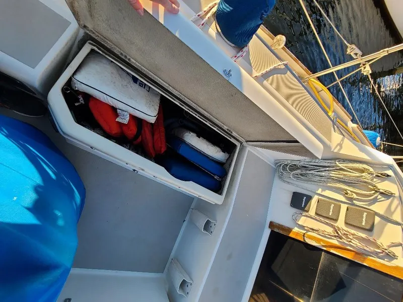 Slide: The Image of Storage compartment on 1985 O'Day 35 sailboat with life jackets and ropes. - 9
