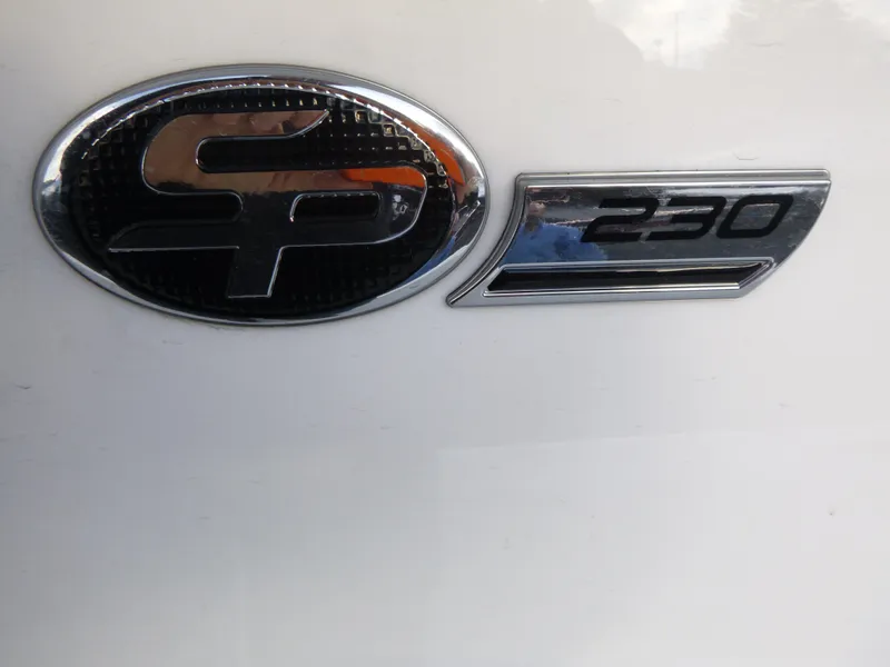 Slide: The Image of 2025 Sea Pro 230 Bay boat storage compartment with open door, showing interior details. - 11