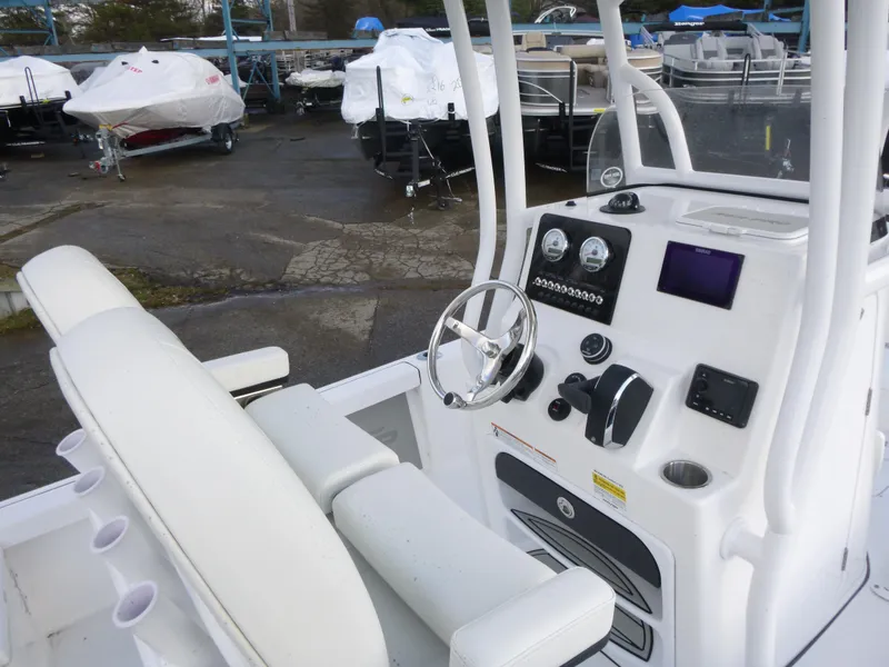 Slide: The Image of 2025 Sea Pro 230 Bay boat console with steering wheel, gauges, and electronic controls. - 13