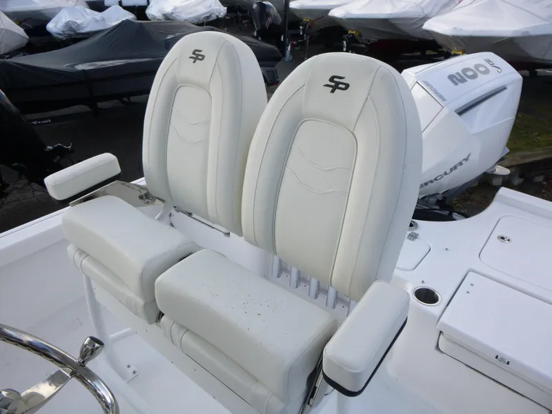 Slide: The Image of 2025 Sea Pro 230 Bay boat deck with motor and storage compartments. - 15