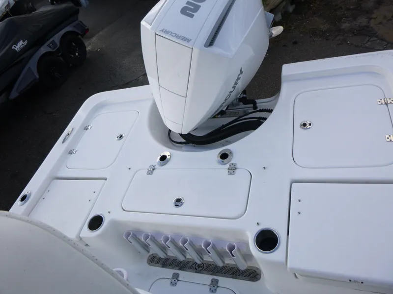 Slide: The Image of 2025 Sea Pro 230 Bay boat interior with rod holders and storage compartments. - 16