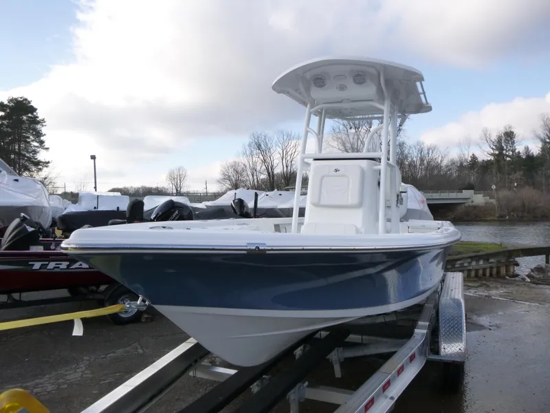 Slide: The Image of 2025 Sea Pro 230 Bay boat on trailer in parking lot, clear sky background. - 3