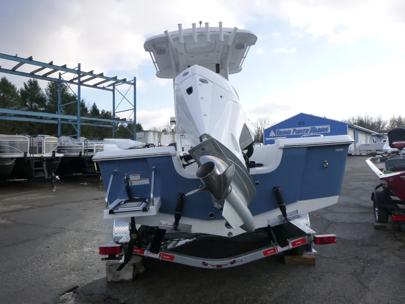 Slide: The Image of 2025 Sea Pro 230 Bay boat parked in a lot under a clear blue sky. - 6