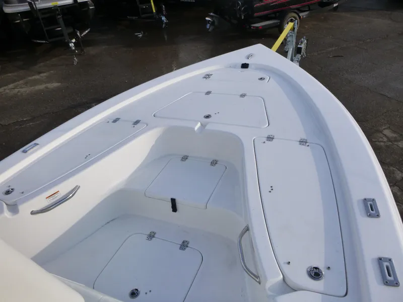 Slide: The Image of 2025 Sea Pro 230 Bay boat docked by a serene lake. - 8